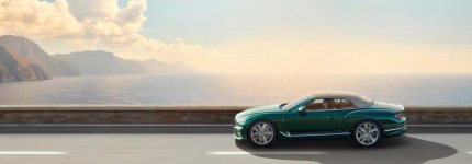 new Verdant green Bentley Continental GT Convertible driving in profile by the sea 1920x670.jpg